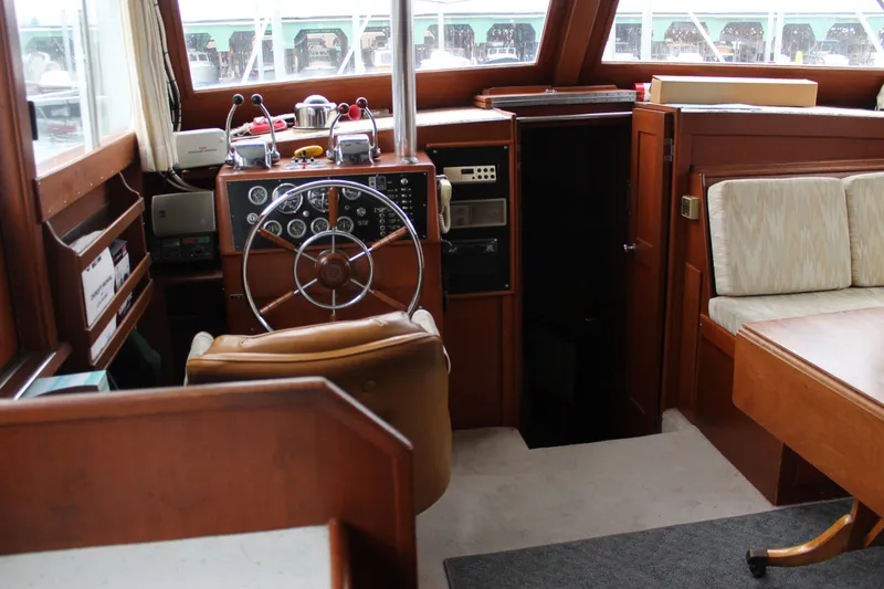 Slide: The Image of 1969 Pacemaker Tricabin boat interior with steering wheel, gauges, and seating area. - 17