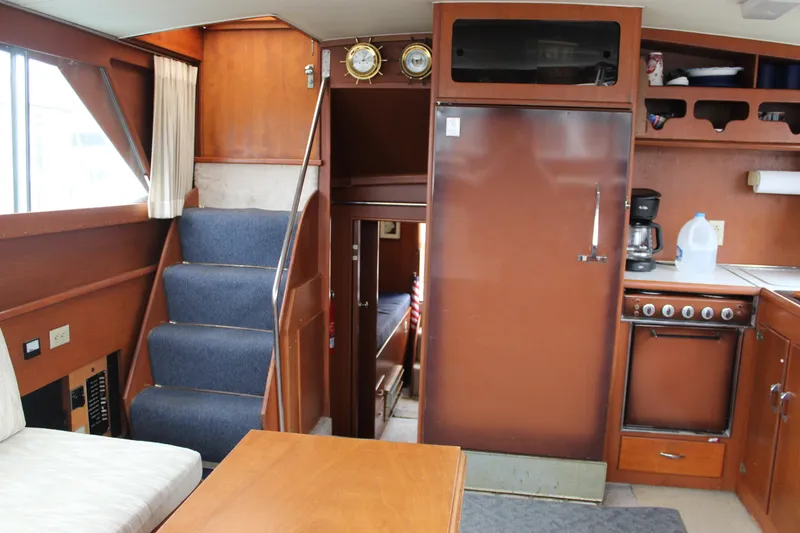 Slide: The Image of 1969 Pacemaker Tricabin interior with stairs, kitchen, and wooden cabinetry. - 19