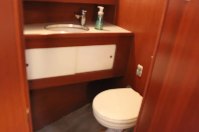 Slide: The Image of 1969 Pacemaker Tricabin bathroom with wooden cabinetry and white fixtures. - 21