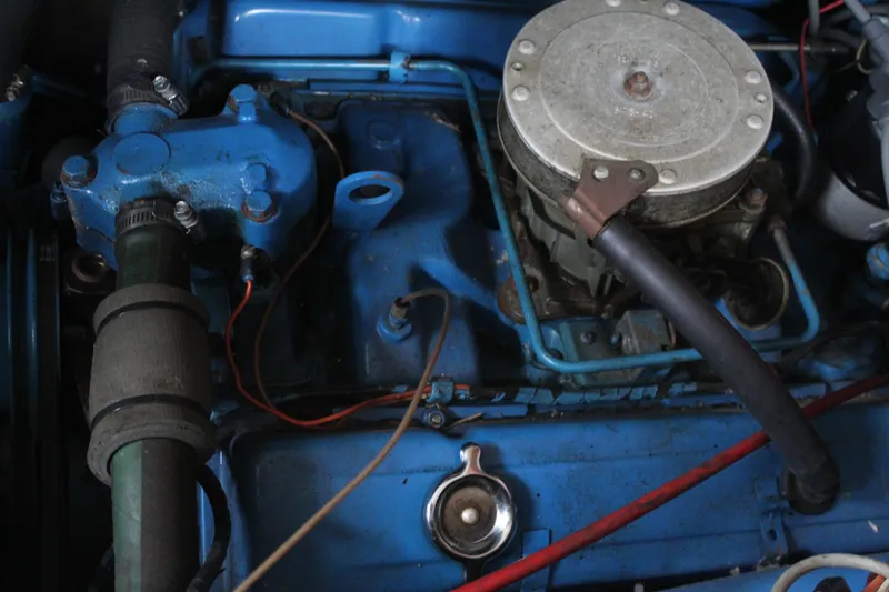 Slide: The Image of 1969 Pacemaker Tricabin engine compartment with blue components and visible wiring. - 23