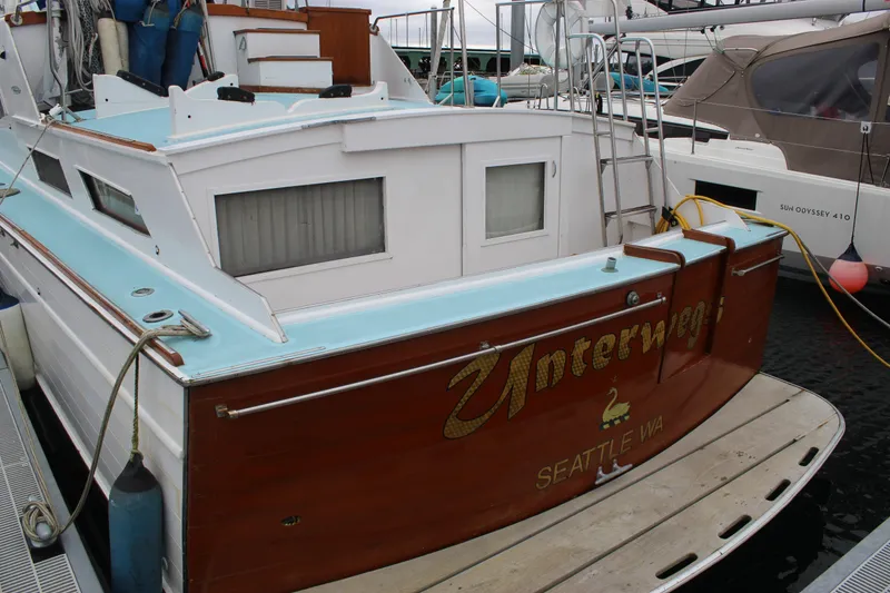 Slide: The Image of 1969 Pacemaker Tricabin boat docked, featuring wooden details and "Unterwegs" lettering, Seattle, WA. - 4