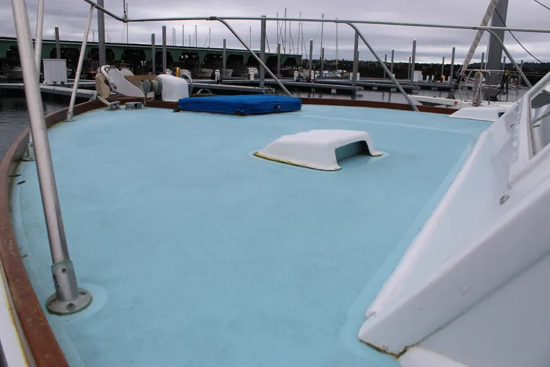 Slide: The Image of 1969 Pacemaker Tricabin boat deck with blue surface, docked at marina. - 7