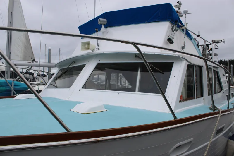 Slide: The Image of 1969 Pacemaker Tricabin boat with blue and white exterior docked at marina. - 8
