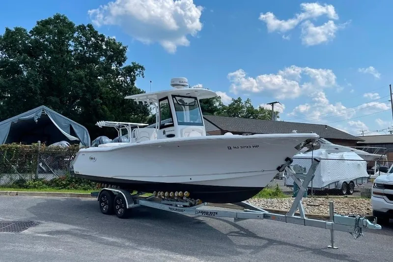 Slide: The Image of 2021 Sea Hunt Ultra 275 SE boat on trailer under blue sky. - 6