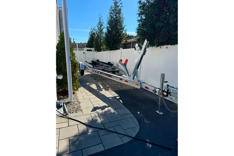 Slide: The Image of Boat trailer parked on driveway, suitable for 2021 Sea Hunt Ultra 275 SE. - 9