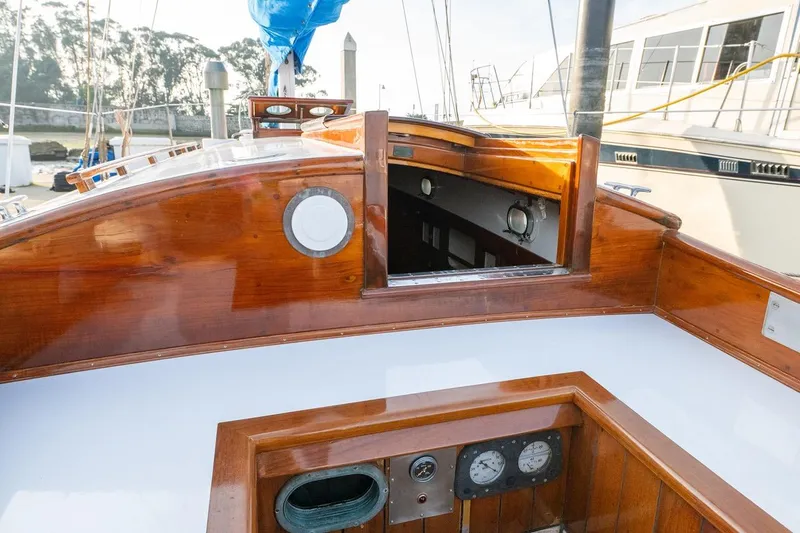Slide: The Image of 1938 Philip Rhodes Cutter sailboat with polished wood interior and nautical instruments. - 22