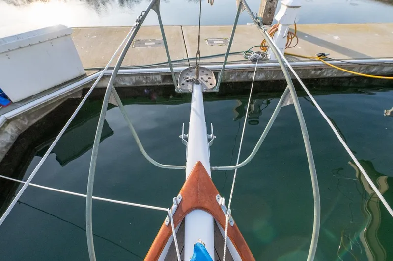 Slide: The Image of Bow view of a 1938 Philip Rhodes Cutter sailboat docked at a marina. - 24