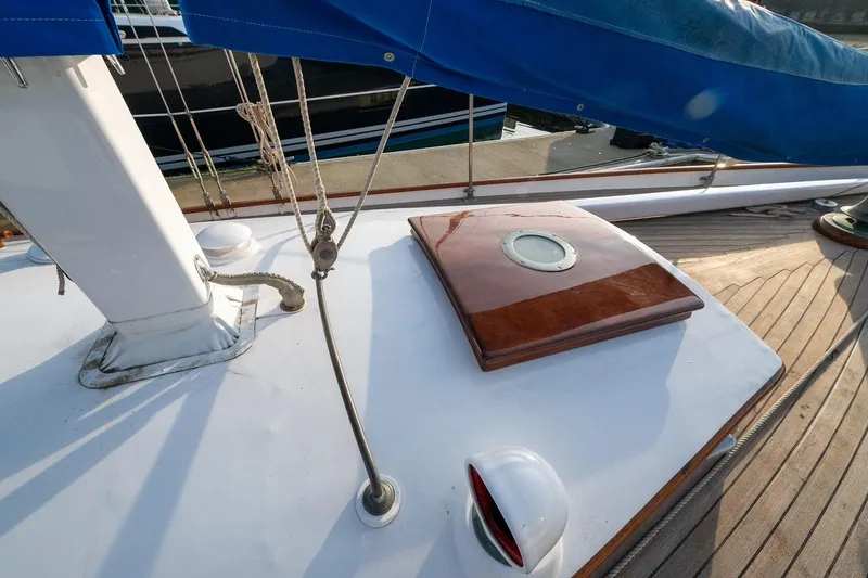 Slide: The Image of 1938 Philip Rhodes Cutter deck with wooden hatch and blue sail cover. - 26