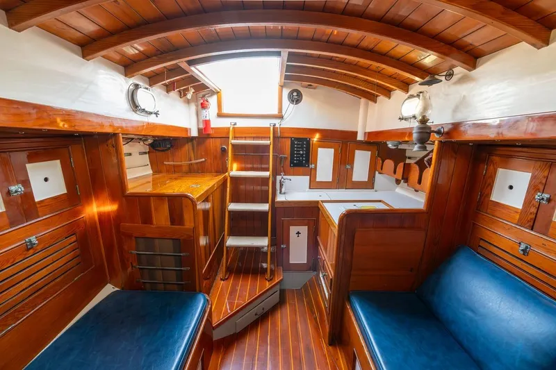 Slide: The Image of Interior of a 1938 Philip Rhodes Cutter, featuring polished wood and classic nautical design. - 34