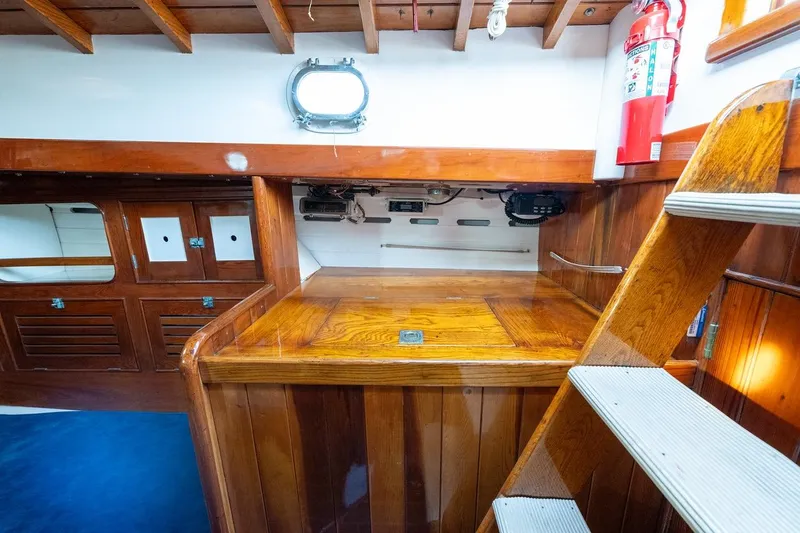 Slide: The Image of Interior of 1938 Philip Rhodes Cutter, featuring wooden cabinetry and nautical elements. - 36