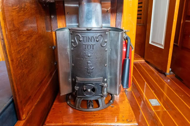 Slide: The Image of Vintage stove on 1938 Philip Rhodes Cutter boat, featuring wooden interior and classic design. - 41