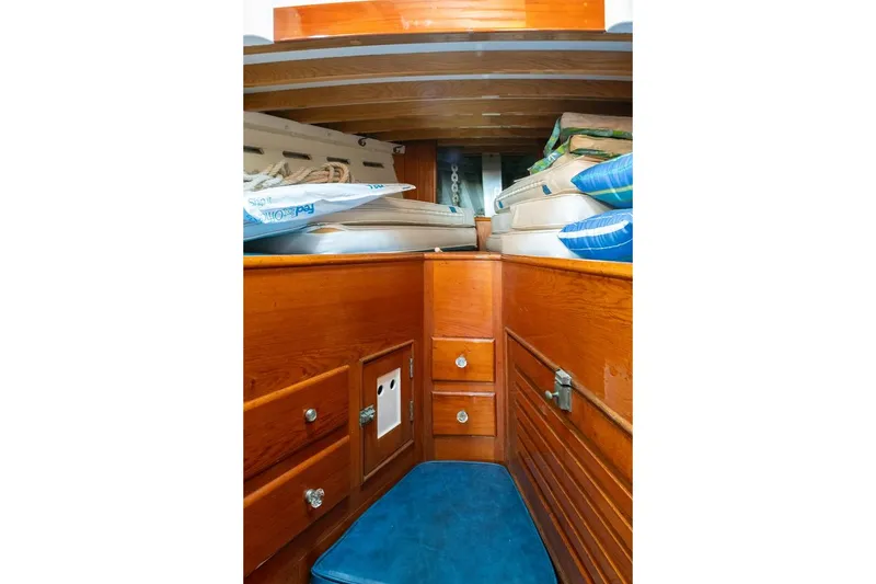 Slide: The Image of Interior of 1938 Philip Rhodes Cutter, featuring wooden cabinetry and blue cushions. - 43