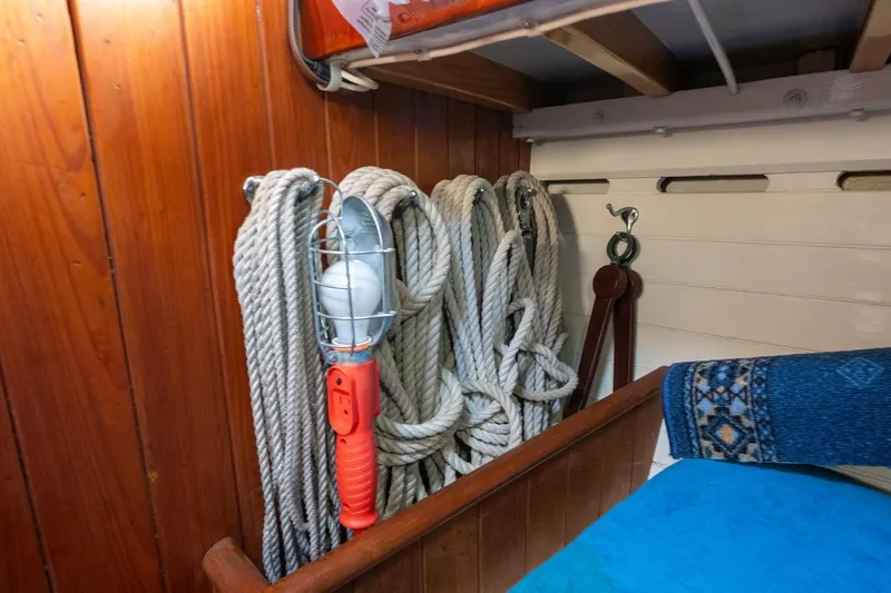 Slide: The Image of 1938 Philip Rhodes Cutter interior with coiled ropes and nautical lamp. - 44