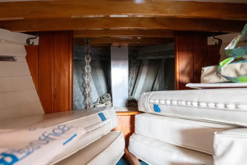 Slide: The Image of Interior of a 1938 Philip Rhodes Cutter, showing anchor chain and cushions. - 45