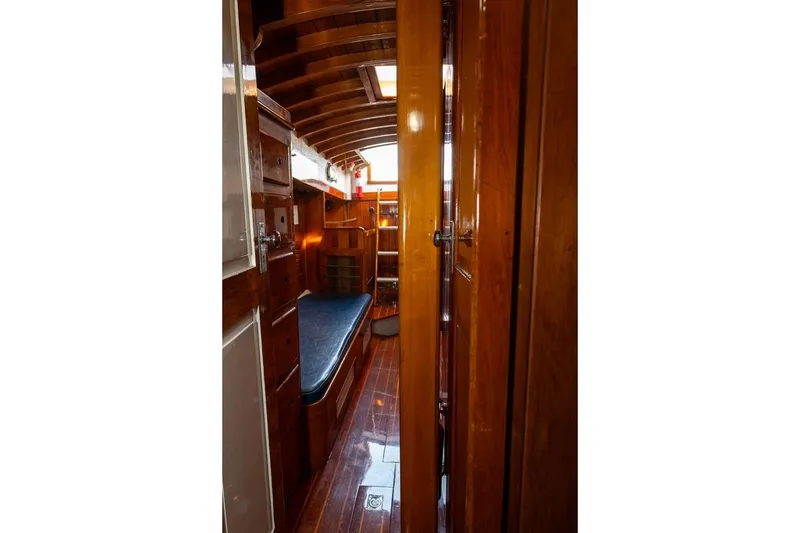 Slide: The Image of Interior of 1938 Philip Rhodes Cutter, showcasing polished wood and classic nautical design. - 46