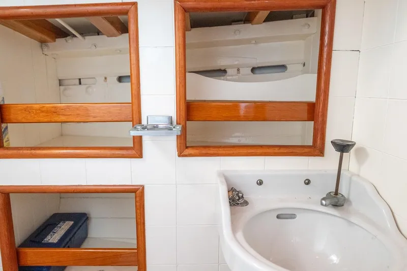 Slide: The Image of 1938 Philip Rhodes Cutter bathroom with wooden shelves and white sink. - 48