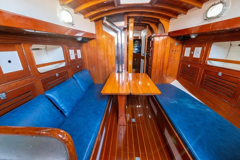 Slide: The Image of Interior of a 1938 Philip Rhodes Cutter with polished wood and blue seating. - 50