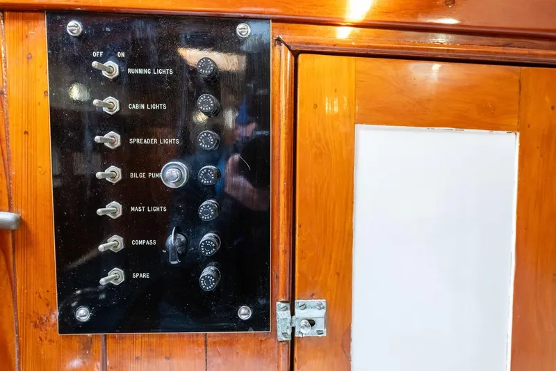Slide: The Image of Control panel on a 1938 Philip Rhodes Cutter, featuring switches for various boat functions. - 53