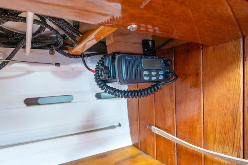Slide: The Image of Radio equipment inside a 1938 Philip Rhodes Cutter boat, featuring wooden interior. - 60