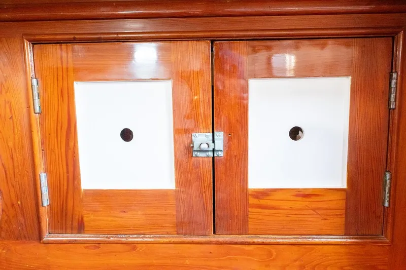 Slide: The Image of Wooden cabinet doors on a 1938 Philip Rhodes Cutter boat interior. - 61