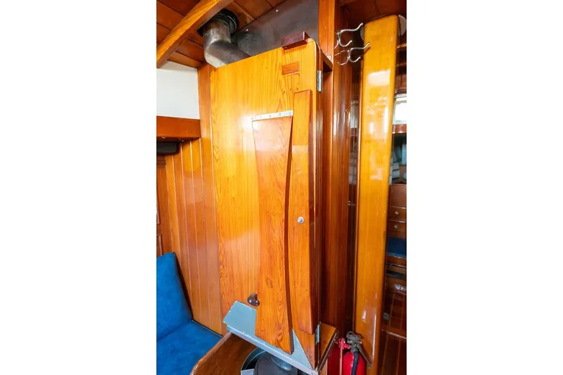 Slide: The Image of Interior of 1938 Philip Rhodes Cutter, featuring polished wooden paneling and blue seating. - 64