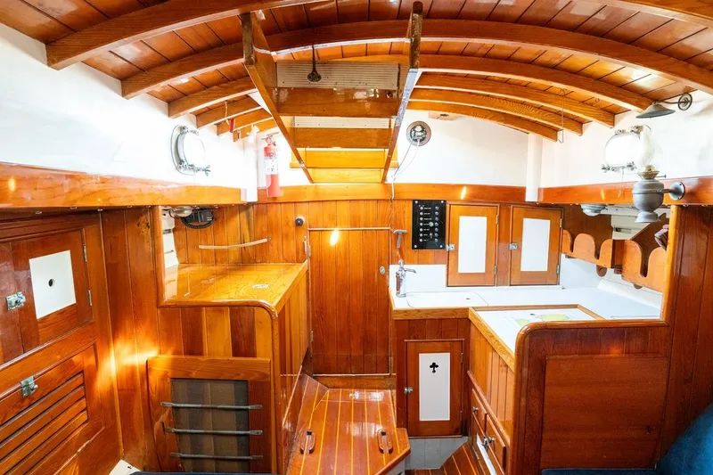Slide: The Image of 1938 Philip Rhodes Cutter interior with wooden cabinetry and classic nautical design. - 69