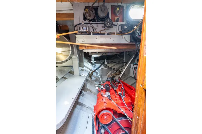 Slide: The Image of Engine room of a 1938 Philip Rhodes Cutter with visible red engine components. - 70