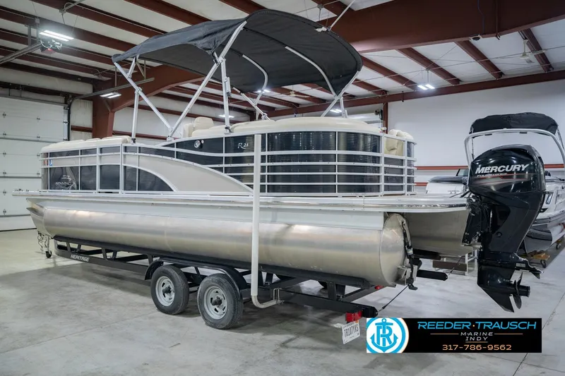 Slide: The Image of 2015 Bennington 2350 RSR pontoon boat with Mercury engine in indoor storage. - 10