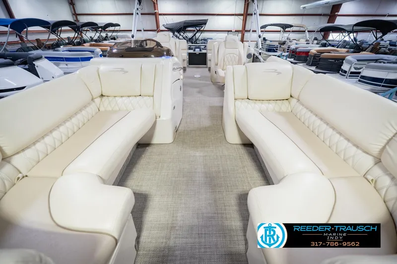 Slide: The Image of Interior view of a 2015 Bennington 2350 RSR pontoon boat with beige seating. - 16