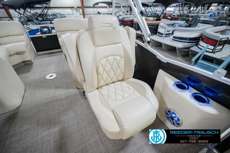Slide: The Image of 2015 Bennington 2350 RSR boat interior with beige seating and illuminated cup holders. - 27