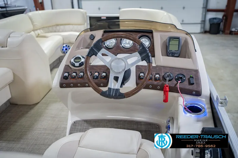 Slide: The Image of 2015 Bennington 2350 RSR boat dashboard with steering wheel and control panel. - 31