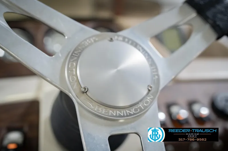 Slide: The Image of Steering wheel of a 2015 Bennington 2350 RSR boat, featuring sleek metallic design. - 33