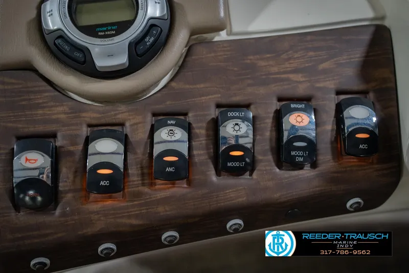 Slide: The Image of Control panel of a 2015 Bennington 2350 RSR boat with various switches and controls. - 34