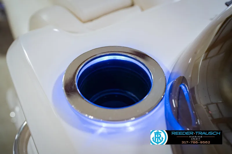 Slide: The Image of Illuminated cup holder on 2015 Bennington 2350 RSR boat, featuring sleek design and blue lighting. - 49