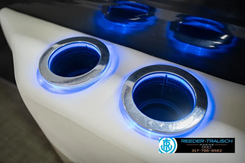 Slide: The Image of Illuminated cup holders on a 2015 Bennington 2350 RSR boat, featuring blue LED lighting. - 50