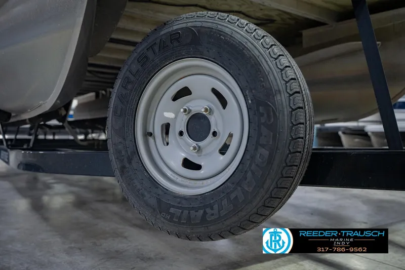 Slide: The Image of Trailer tire of a 2015 Bennington 2350 RSR pontoon boat on display. - 61