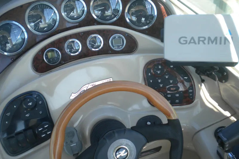 Slide: The Image of 2002 Sea Ray Sundancer 280 dashboard with Garmin navigation system and wood-trimmed steering wheel. - 10