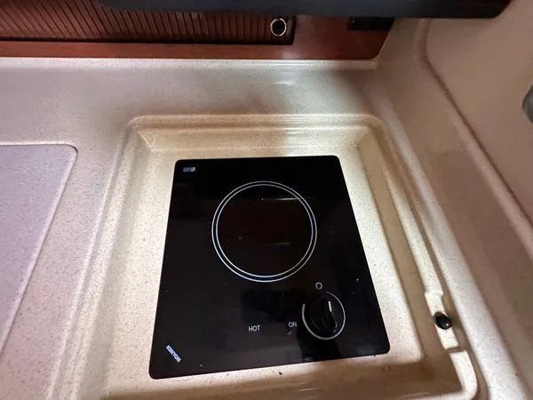 Slide: The Image of Stovetop on 2002 Sea Ray 280 Sundancer yacht, featuring a sleek black design. - 25