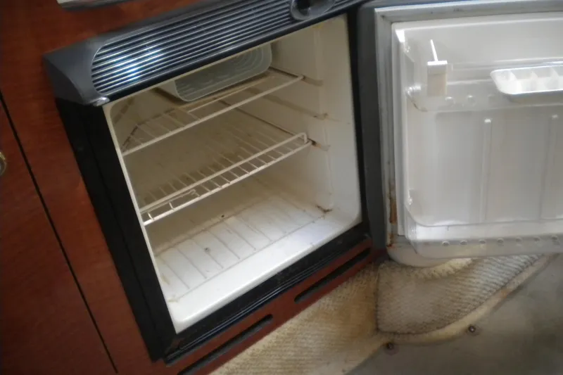 Slide: The Image of Open refrigerator inside a 2002 Sea Ray 280 Sundancer boat cabin. - 29