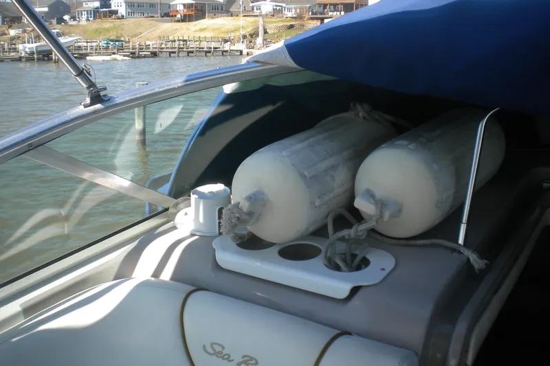 Slide: The Image of 2002 Sea Ray Sundancer 280 with fenders, docked near waterfront homes. - 35