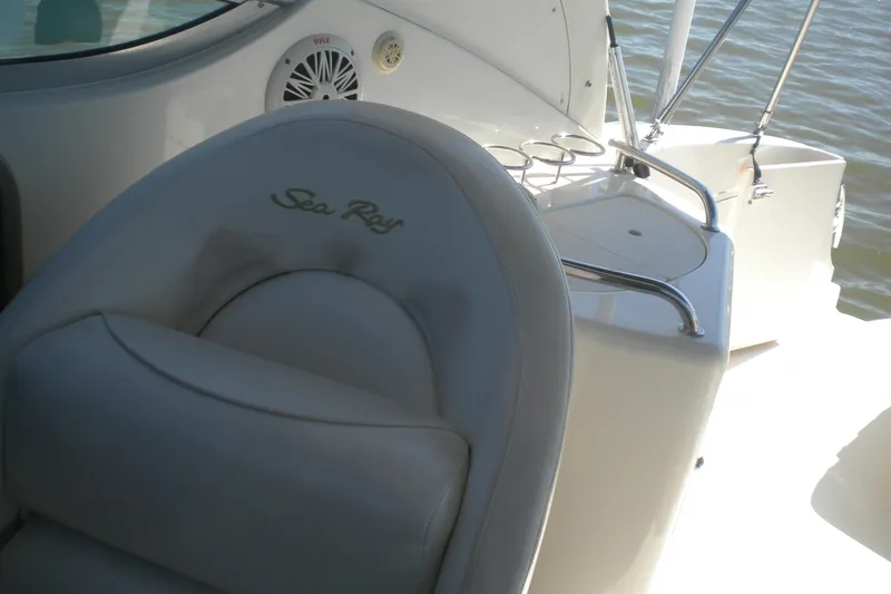 Slide: The Image of 2002 Sea Ray Sundancer 280 boat interior with seating and cup holders. - 36
