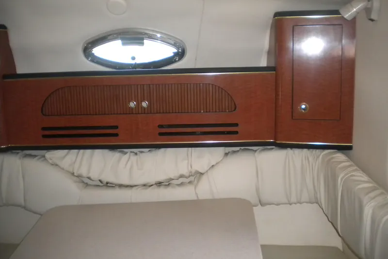Slide: The Image of Interior of 2002 Sea Ray Sundancer 280 with wood cabinetry and cushioned seating. - 38