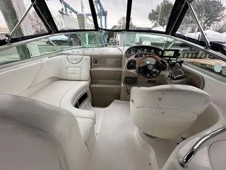 Slide: The Image of Interior of 2002 Sea Ray 280 Sundancer boat with white seating and control panel. - 4