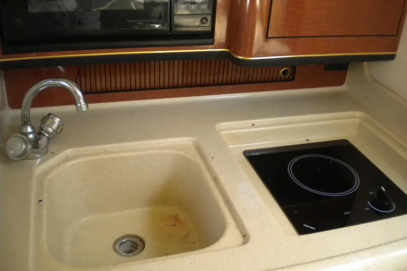 Slide: The Image of 2002 Sea Ray Sundancer 280 kitchen with sink and stovetop. - 41