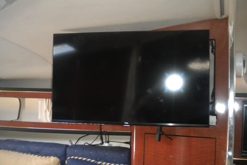 Slide: The Image of Flat-screen TV inside 2002 Sea Ray Sundancer 280 yacht cabin, mounted on wooden panel. - 43