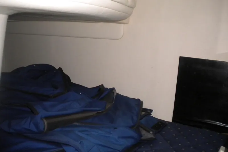 Slide: The Image of Interior cabin of 2002 Sea Ray Sundancer 280 with blue jackets on bed. - 45