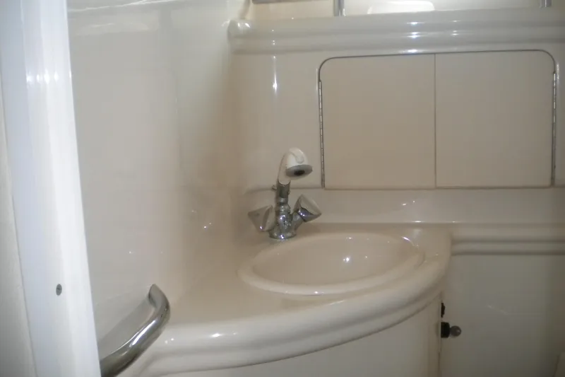 Slide: The Image of 2002 Sea Ray Sundancer 280 bathroom sink with modern fixtures and storage cabinets. - 46