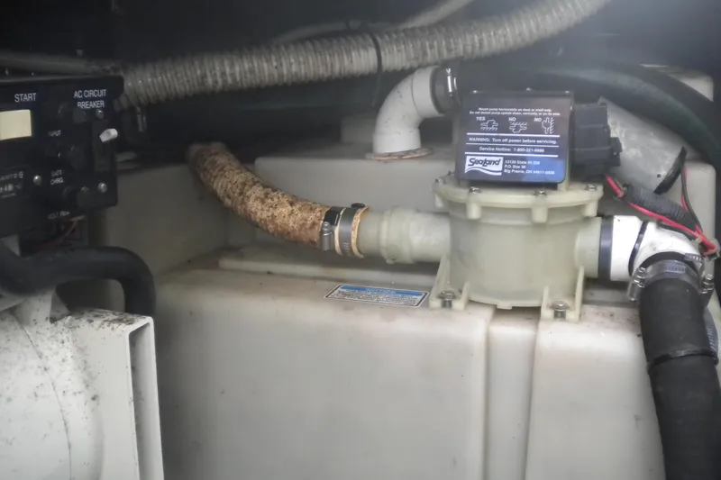 Slide: The Image of Engine compartment of a 2002 Sea Ray Sundancer 280 boat, showing mechanical components. - 48