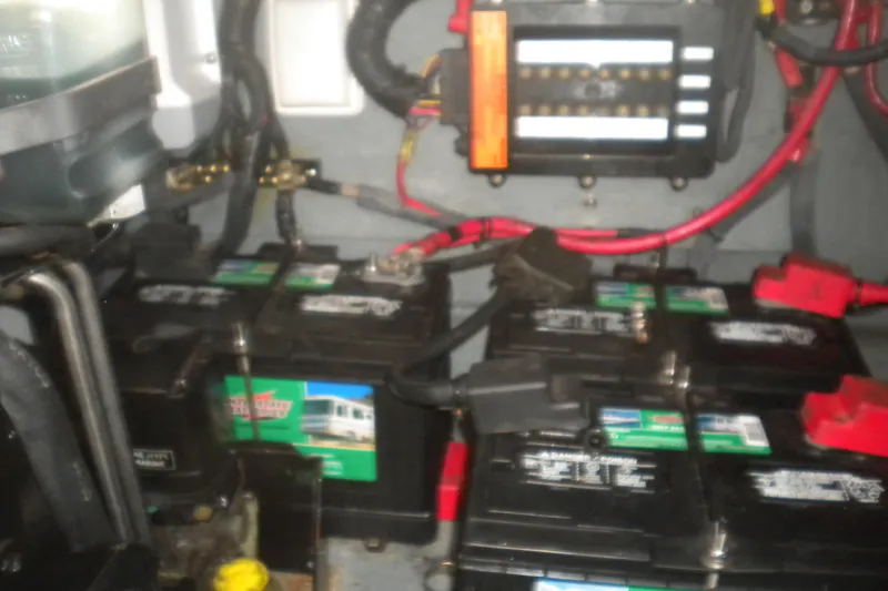Slide: The Image of Battery compartment of a 2002 Sea Ray 280 Sundancer with wiring and connections. - 49