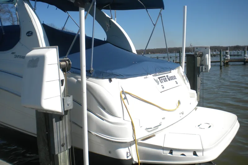 Slide: The Image of 2002 Sea Ray Sundancer 280 docked, covered with blue tarp, at a marina. - 5